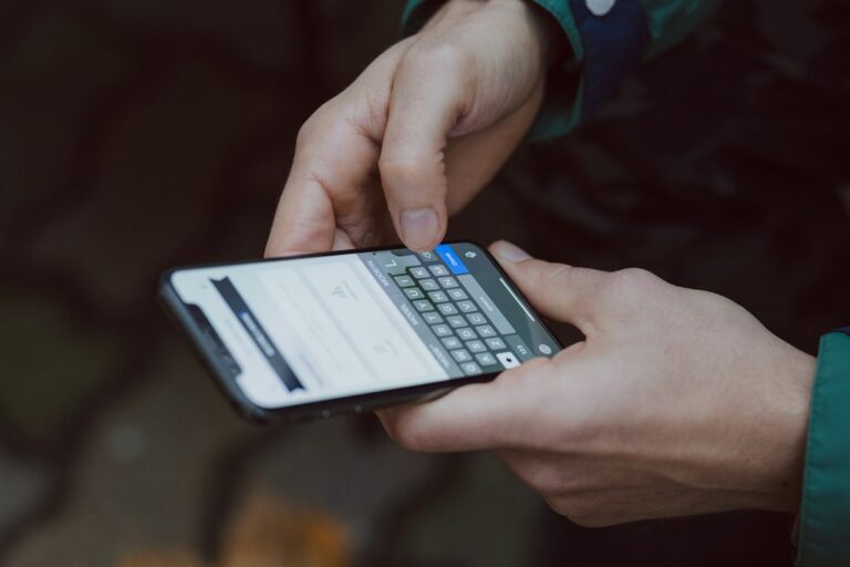A person typing on a smartphone, setting up a new eSIM profile after a transfer